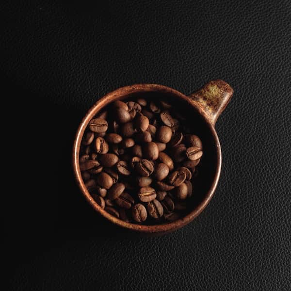 top view of a mug filled with ethical coffee beans