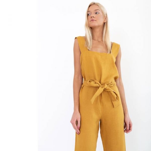 blond woman in mustard linen jumpsuit