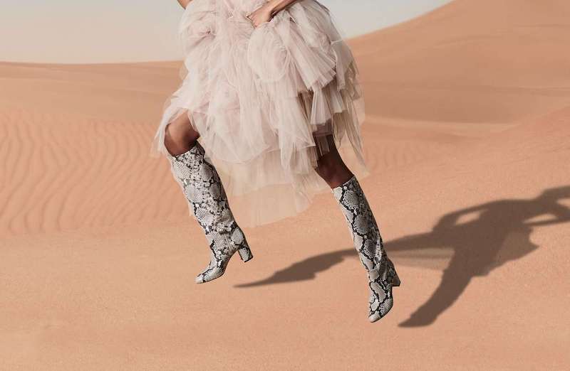 woman in a desert wearing eco friendly winter boots 