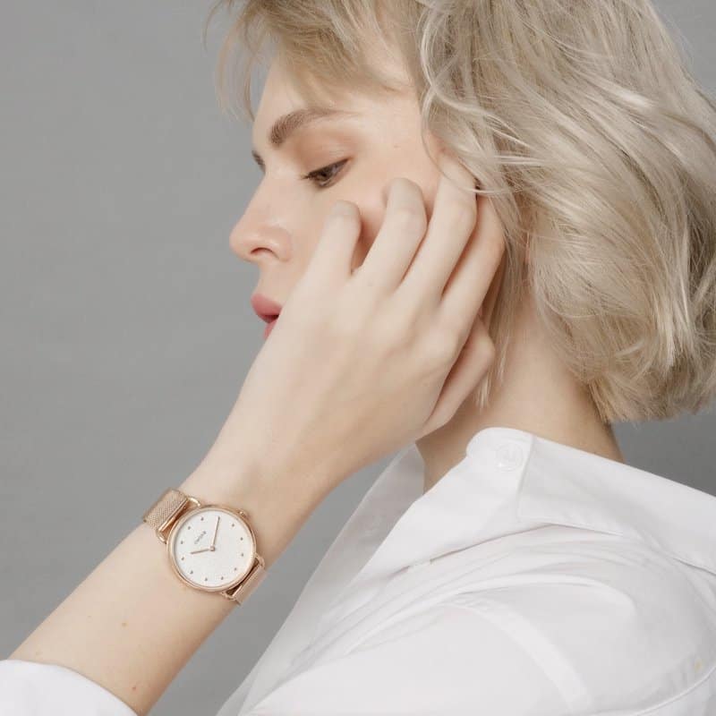 Blonde woman wearing an Awake watch on her left wrist