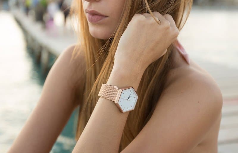 Woman wearing hexagonal Solgaard watch on her left wrist