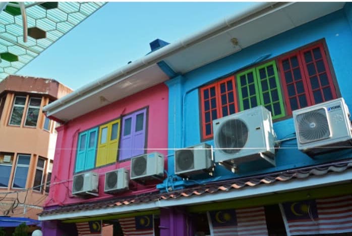 outdoor air-conditioning units seen outside a colorful building