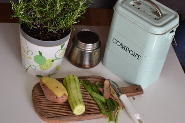 zero waste kitchen composting with a compost bin, some vegetable scraps, etc