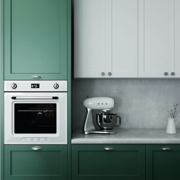 in-built oven in a green kitchen, along with an electric whisk on the countertop