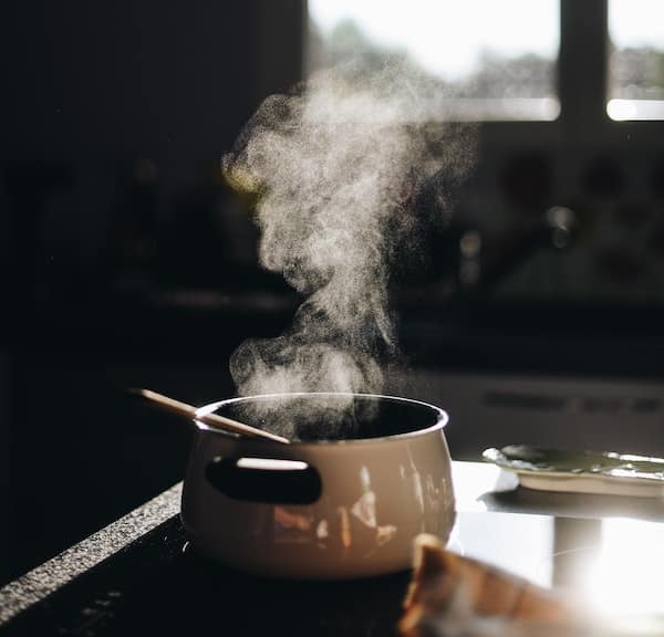pot on a stove with steam rising above it