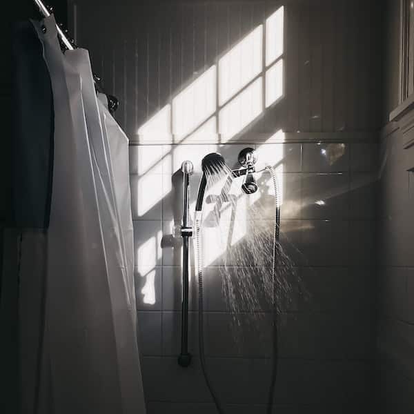 view of a bathroom with shower spraying water