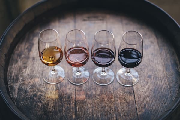 Four wine glasses with four types of wine in sustainable wineries california