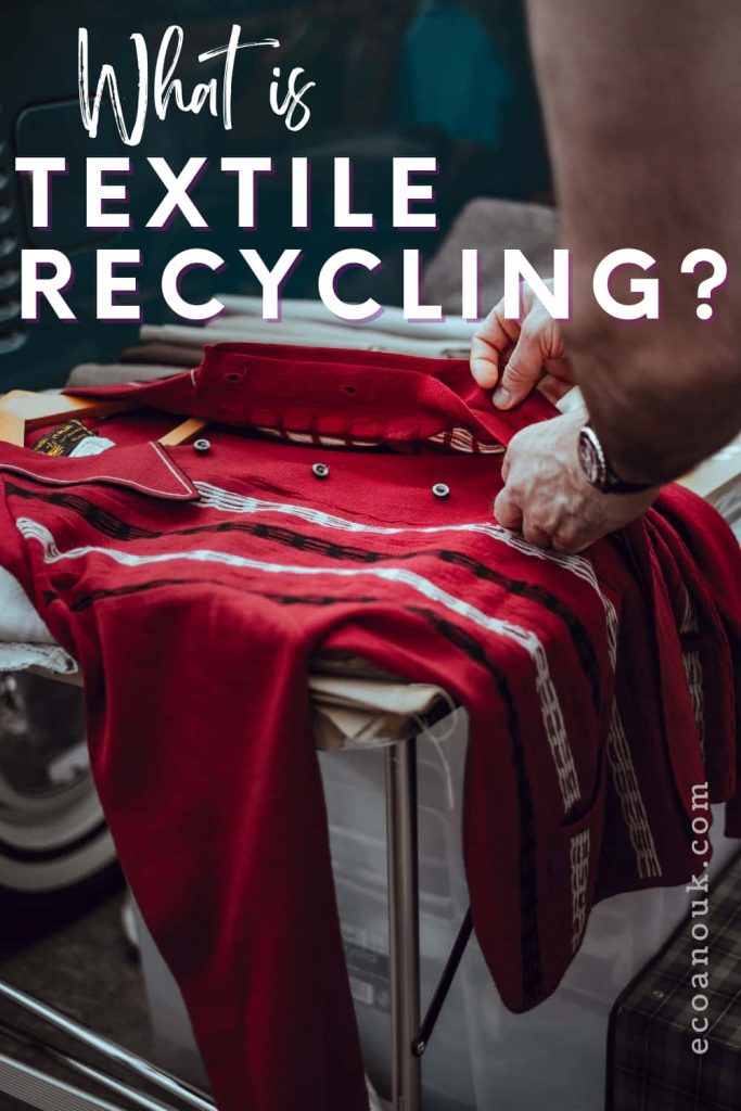 a man buttoning up a red shirt on a table for recycling